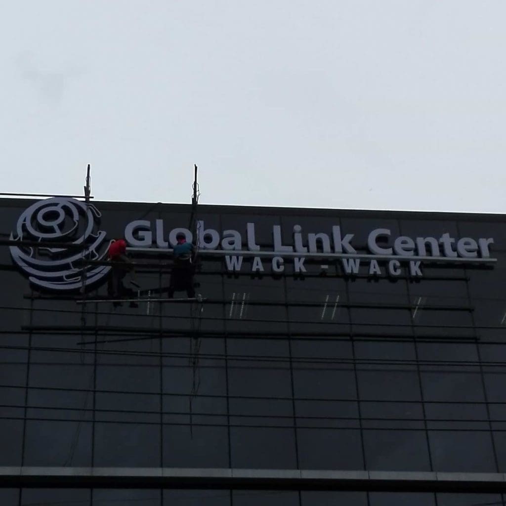 Acrylic signage installation for Global Link Center Wack-Wack on glass building in Mandaluyong by M&G Global Ads.